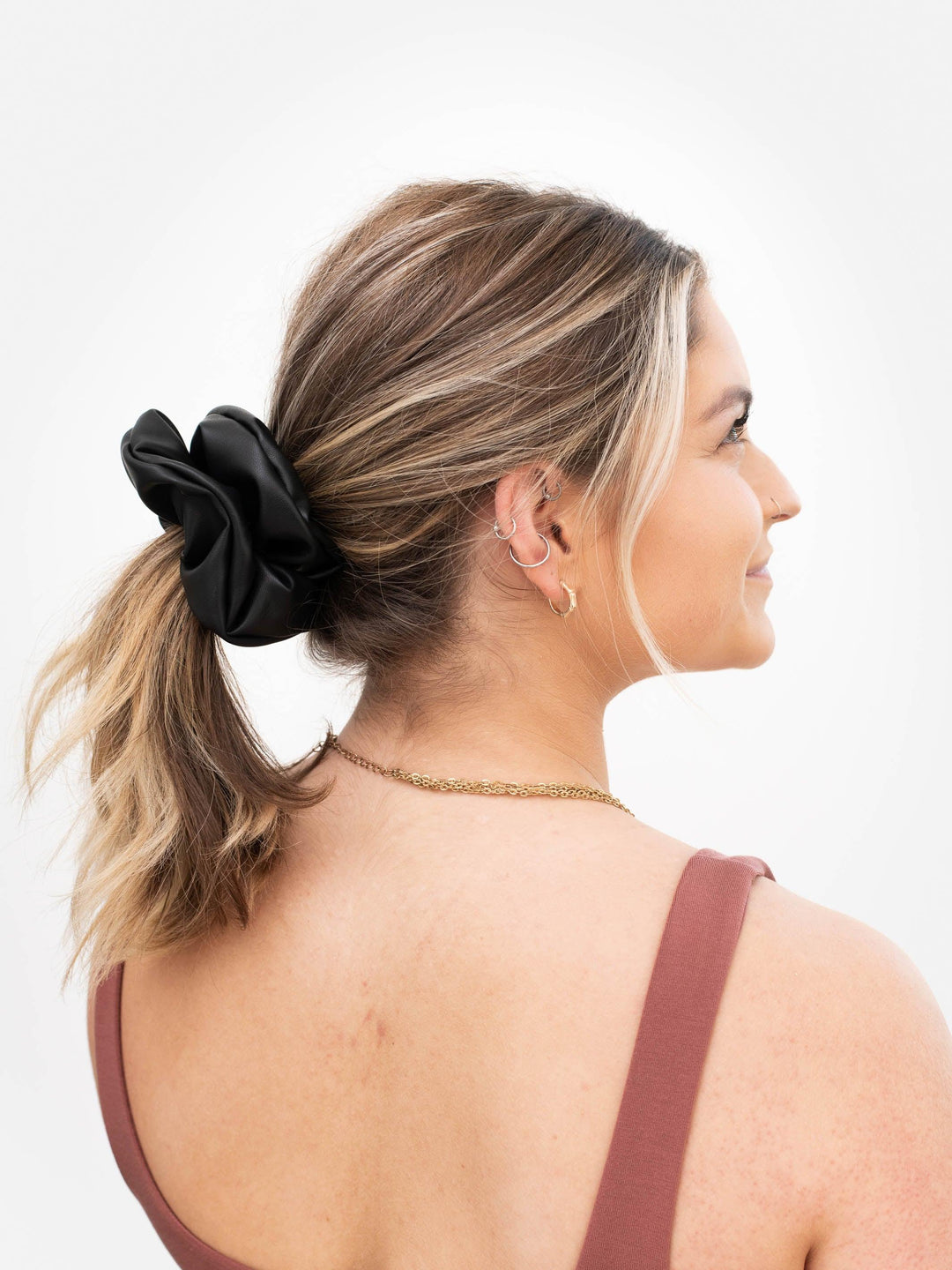 Black Faux Leather Scrunchie size: Next Level in blonde hair ponytail