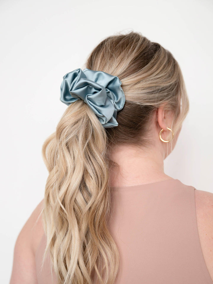 Blue Ivy (Teal) Satin scrunchie holding a ponytail in place – designed for all hair types
