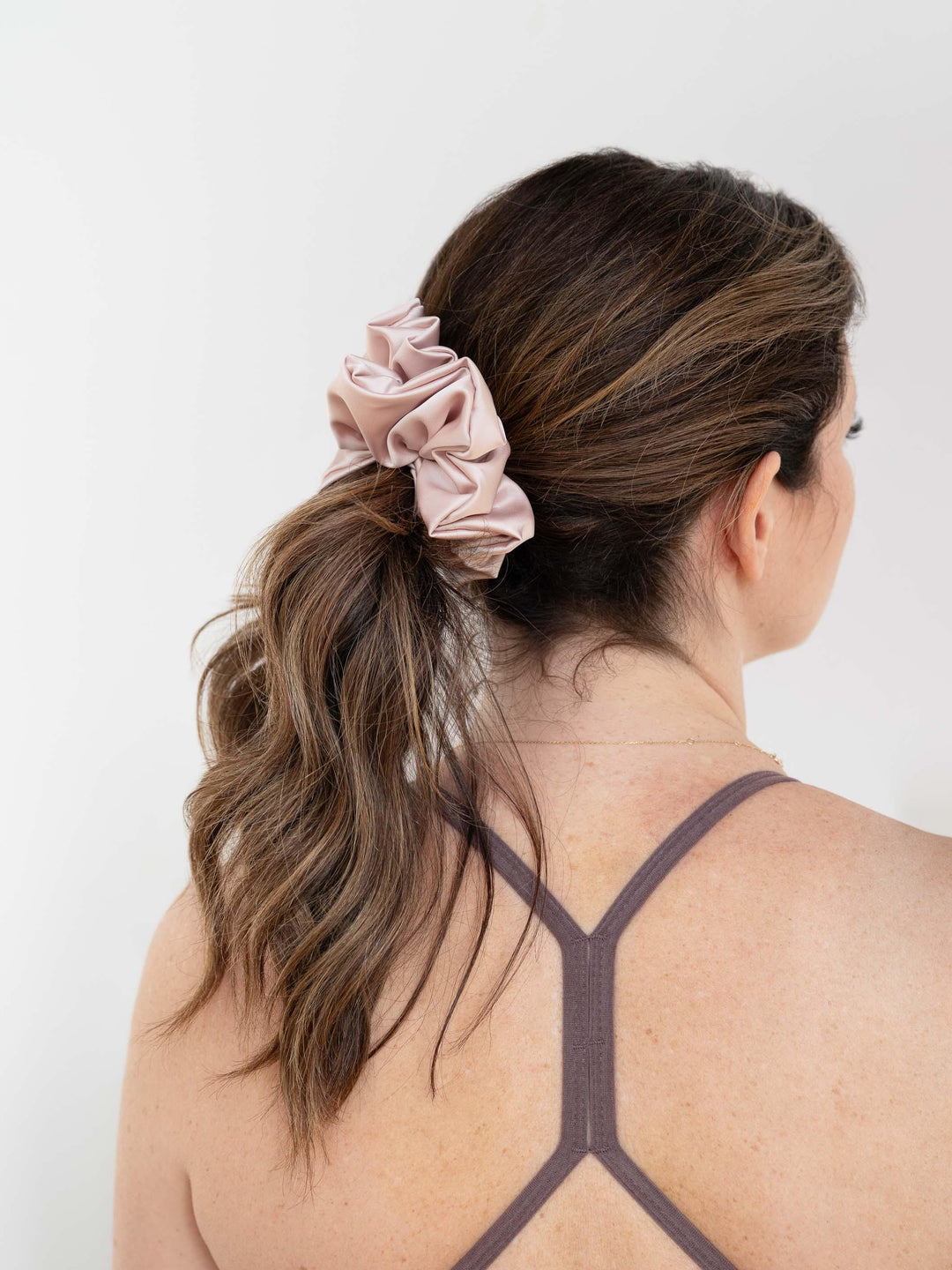 Flirty Pineapple blush satin scrunchie securing a ponytail – perfect for everyday wear