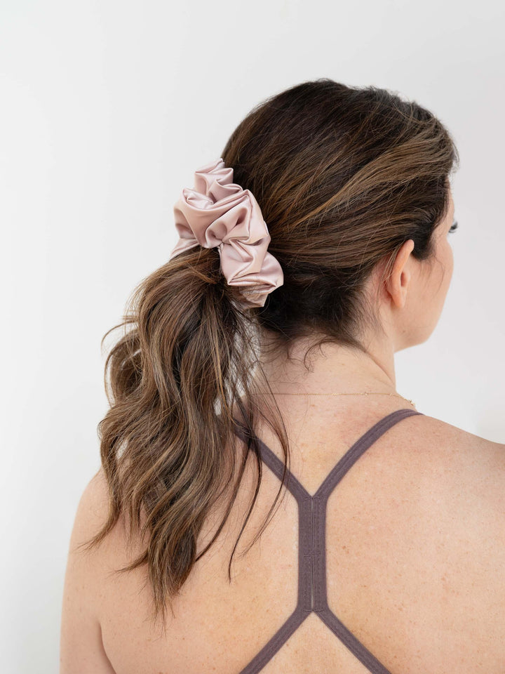 Flirty Pineapple blush satin scrunchie securing a ponytail – perfect for everyday wear