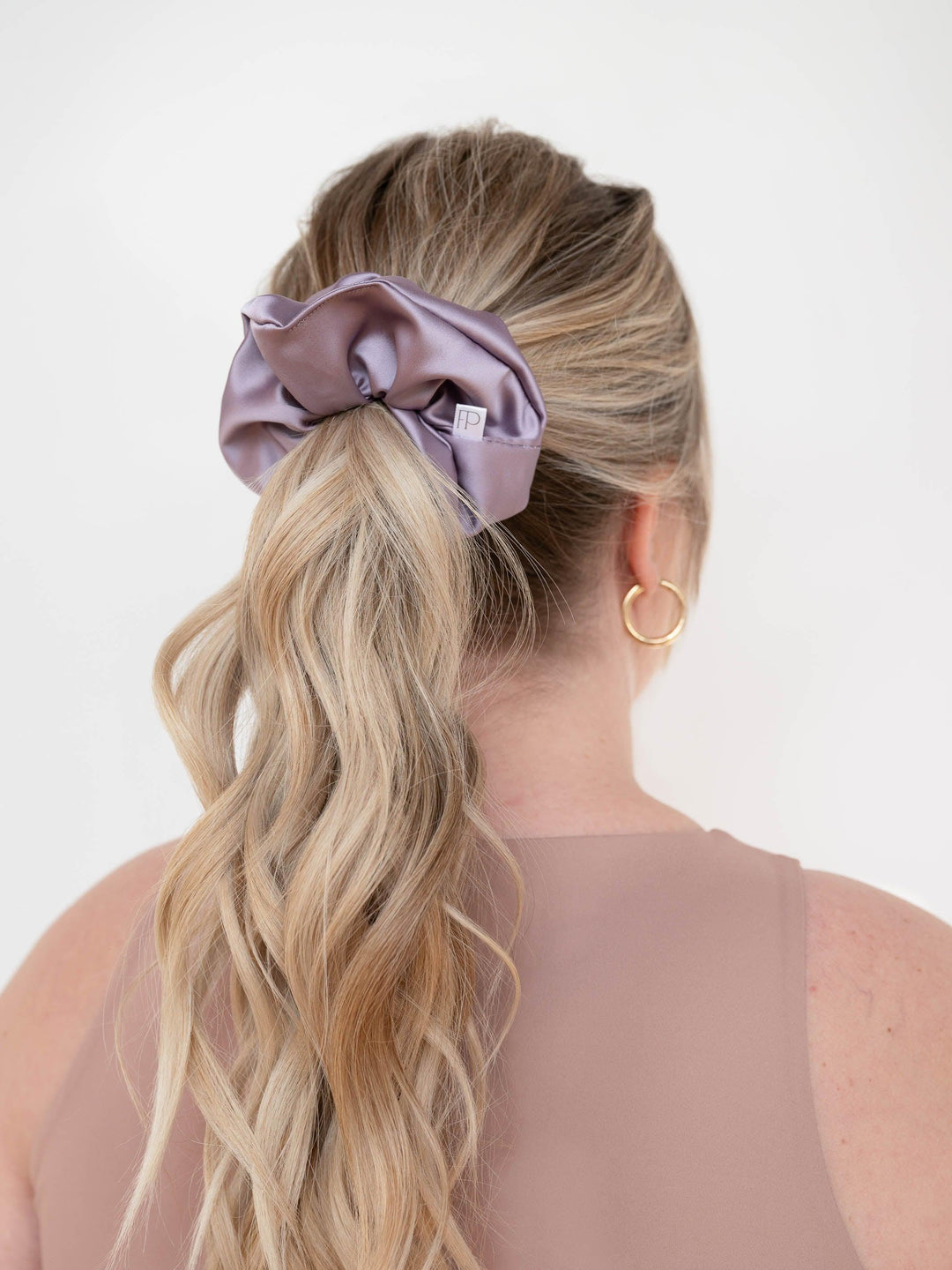 Back view of a ponytail styled with a dusty lavender purple satin scrunchie – soft and secure hold