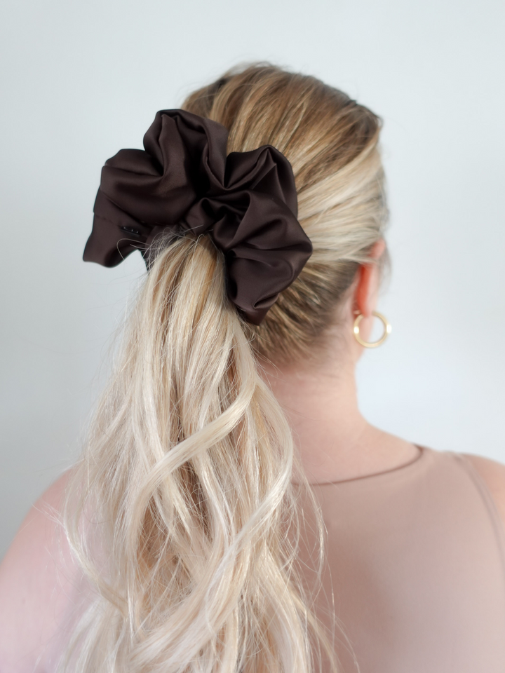 Close-up of a ponytail secured with an espresso brown satin scrunchie – frizz-free styling