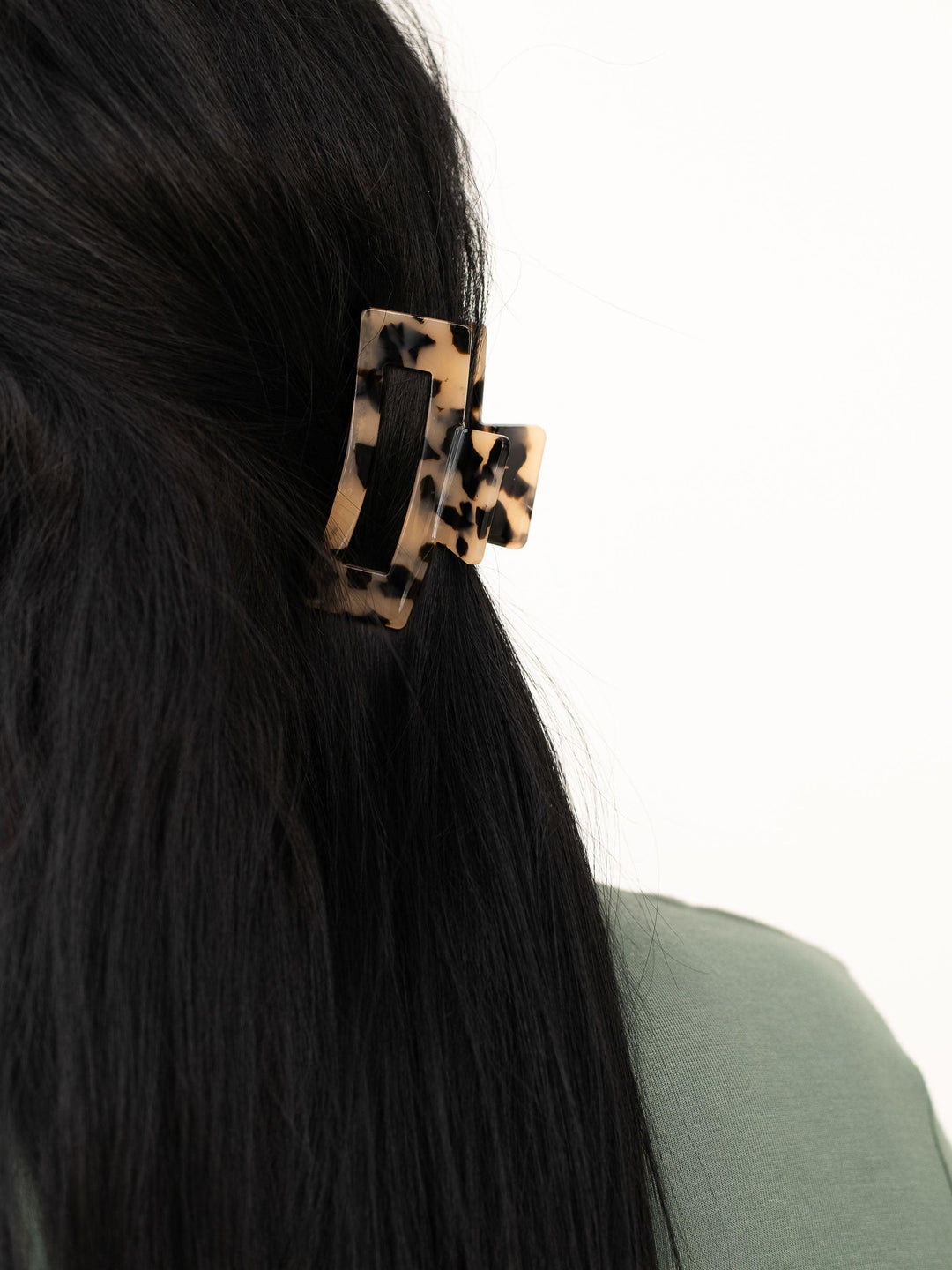 Close-up of small (basic) claw clip in light tortoise shell, designed for thin hair.