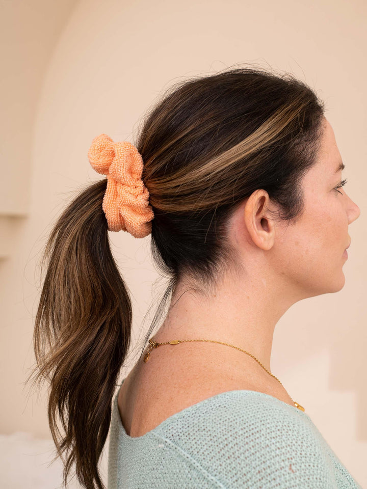 Peach microfiber towel scrunchie in a ponytail - useful for all hair types