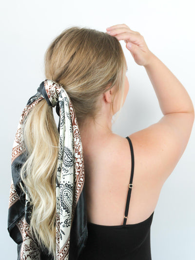 Black and White Paisley hair scarf in blonde hair around ponytail with brown accent